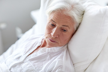 senior woman patient lying in bed at hospital ward