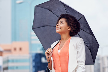 happy african american businesswoman with umbrella