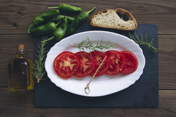 tomato dish with bread, olive oil and peppers