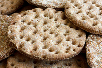 Heap of round rye crispbreads as a background.