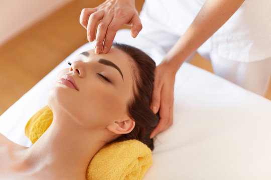 Spa Woman. Beautiful Young Woman Getting a Face Treatment at Beauty Salon