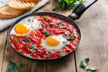 fried eggs in tomato sauce in the pan