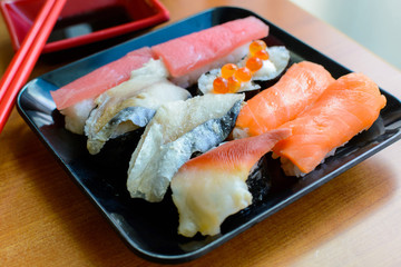 set of japanese sushi on the black plate