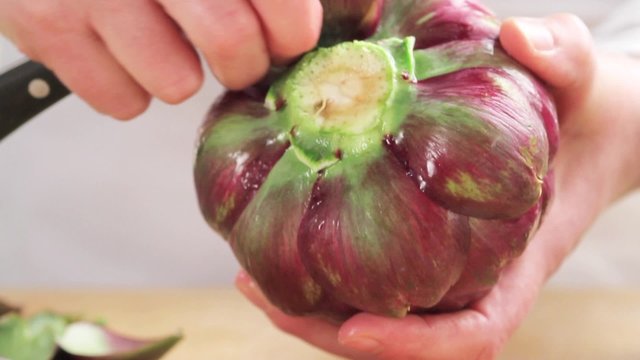 Removing lower leaves from artichokes