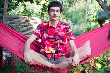 a young man  in a red hammock