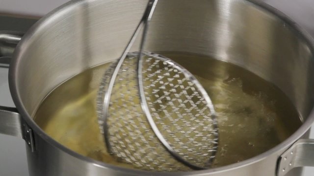 Placing calamari into hot oil