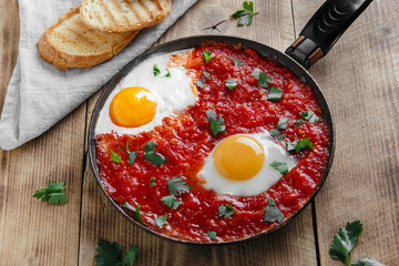fried eggs in tomato sauce in the pan