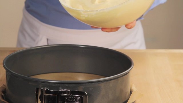 Sponge cake mixture being poured into a springform tin