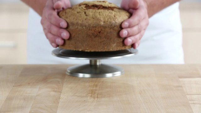 Carrot cake being sliced twice horizontally