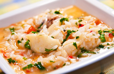 Authentic portuguese food: Delicious soup-like rice with codfish - obrazy, fototapety, plakaty