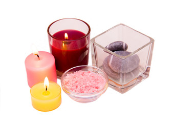 Candles and bath salts on white background