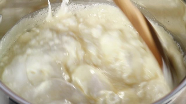 Chocolate fudge being made: marshmallows, sugar, condensed milk and butter being brought to the boil