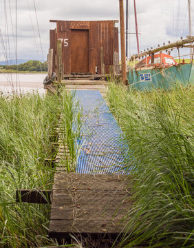 Skipool Creek, Thornton Cleveleys, Lancashire, UK. August 11th 2015. The old wooden huts at low tide at Skipool Creek, Lancashire, uk.