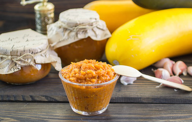 Caviar squash in banks and in a bowl, garlic, and zucchini on the table