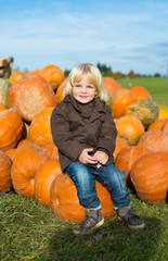Little smiling boy at the pumpkin patch