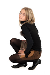 Fototapeta premium Beautiful girl doing different expressions in different sets of clothes: kneeling