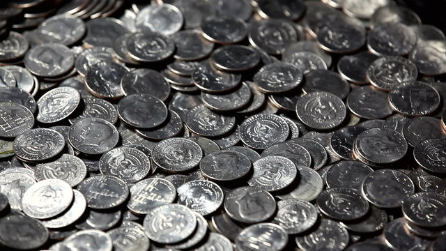 large pile of silver coins falling
