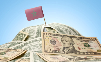 Flag of Morocco sticking in a pile of american dollars.(series)