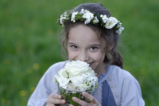 Germany, Portrait of a flower girl with flower wrath in hair