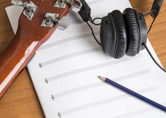 headphone guitar notebook and pencil