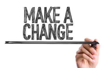 Hand with marker writing the word Make a Change