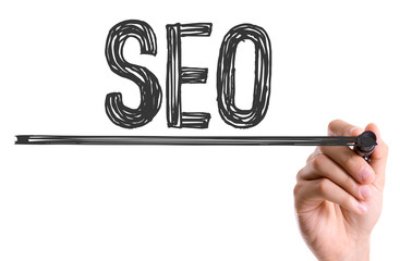 Hand with marker writing the word SEO