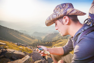 Tourist's hand with a compass in the mountain of Switzerland