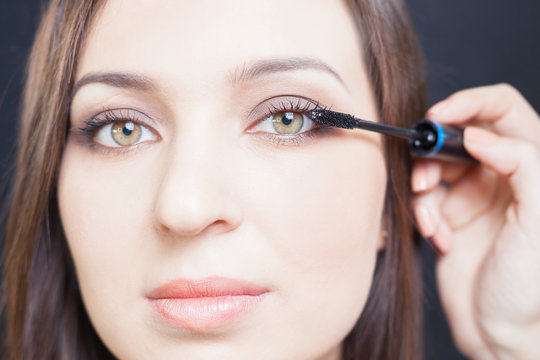 makeup artist doing make up for beautiful arabian woman