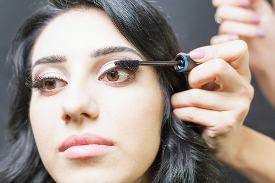 makeup artist doing make up for beautiful arabian woman