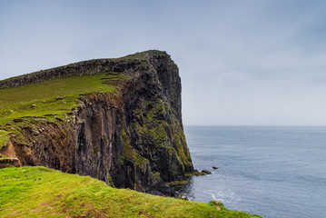 Fototapeta na wymiar Mountains and ocean in Neist Point, isle of Skye, Scotland