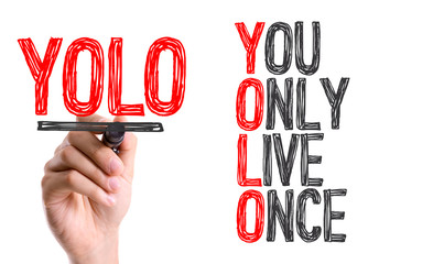 Hand with marker writing the word You Only Live Once