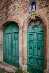 Fototapeta na wymiar Green door at Toiano, ghost town in Italy