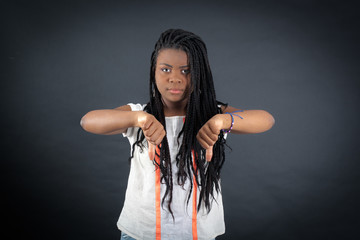 Beautiful girl doing different expressions in different sets of clothes: thumbs down