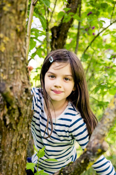 Portrait of girl climbing in a tree