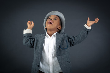 Handsome boy doing different expressions in different sets of clothes: joy