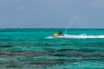 Mother and daughter riding a jet ski.