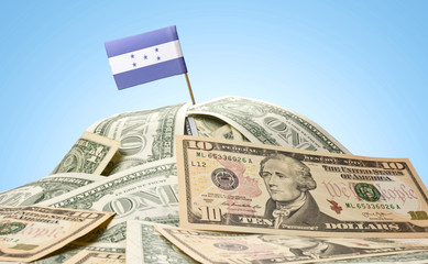 Flag of Honduras sticking in a pile of american dollars.(series)