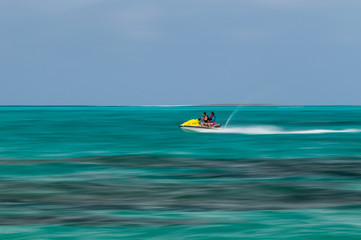 Mother and daughter riding a jet ski.