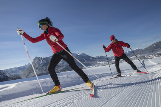 Germany, Bavaria, Inzell, skiers in snow-covered landscape