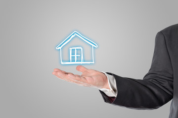 Businessman, salesman, house symbol in the hand