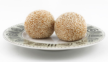 Traditional asian dessert, two sesame balls on the plate