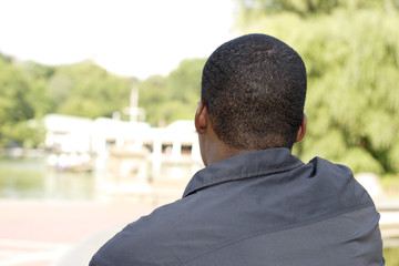 Back of man looking at summer scene.