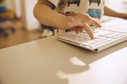 Little Boy's Finger Typing On The Keyboard Of A Computer