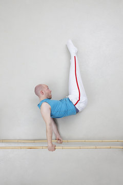 Man exercising on parallel bars