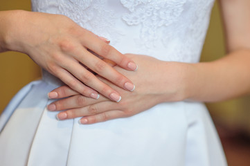 Fototapeta na wymiar hands of a bride with a wedding manicure