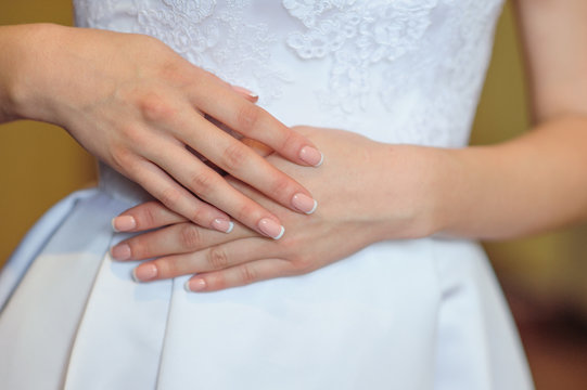 hands of a bride with a wedding manicure