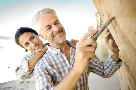 South Africa, portrait of man carving something in rock face
