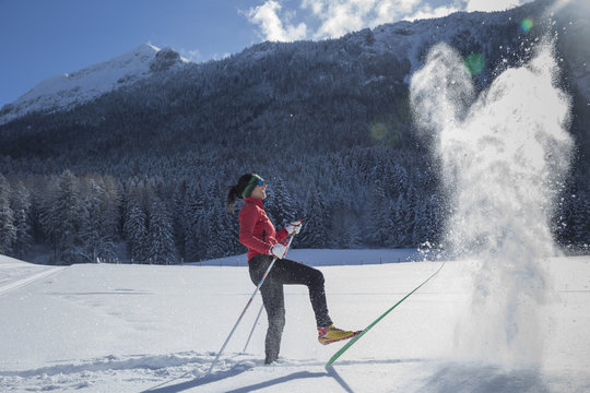 Germany, Bavaria, Inzell, female skier having fun in snow-covered landscape