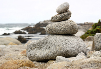 Naklejka na ściany i meble Stack of rocks by the ocean
