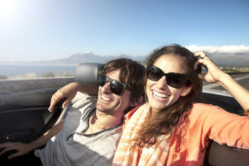South Africa, happy couple in convertible on coastal road
